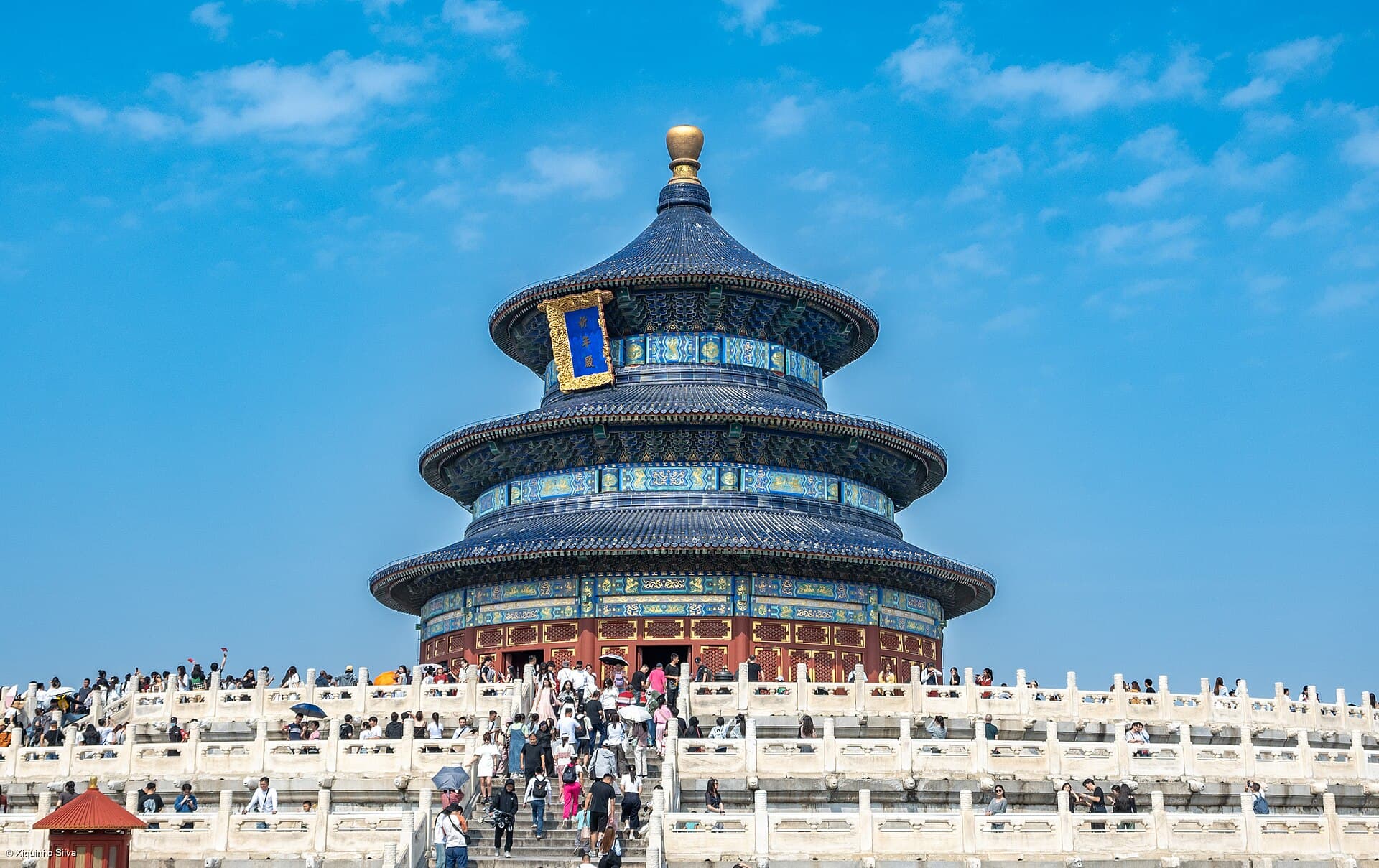 The round, blue-tiled, three-tiered Hall of Prayer for Good Harvests at the Temple of Heaven, with visitors on the marble terrace
