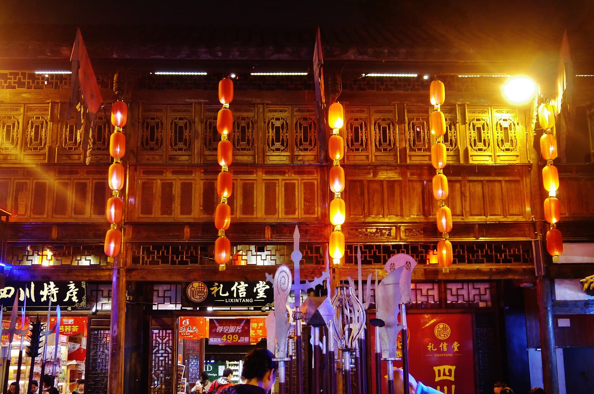 Red lanterns hanging along the old-style timber shopfronts of Jinli street in Chengdu at night